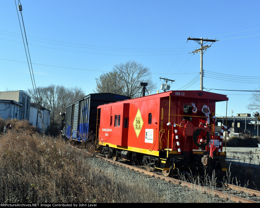 The caboose bringing up the rear of the train as it heads toward Freehold and Jamesburg